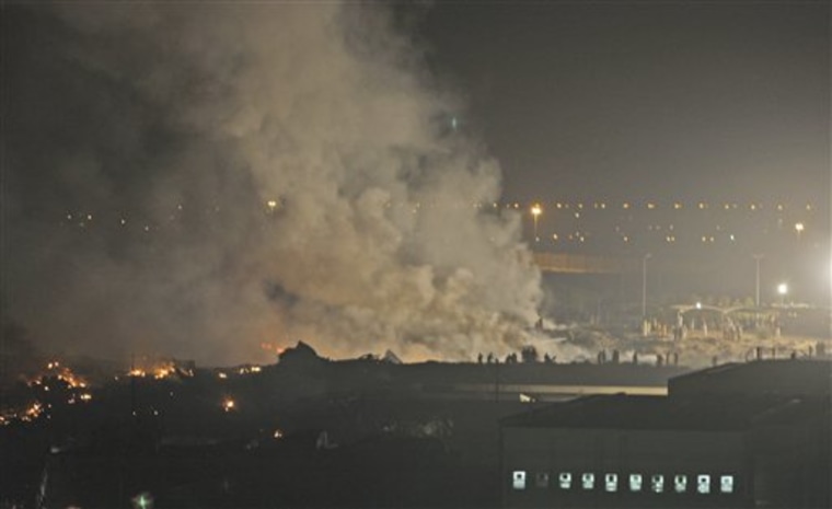 Smoke rises from the site of the UPS cargo plane crash in Dubai, United Arab Emirates, on Friday.